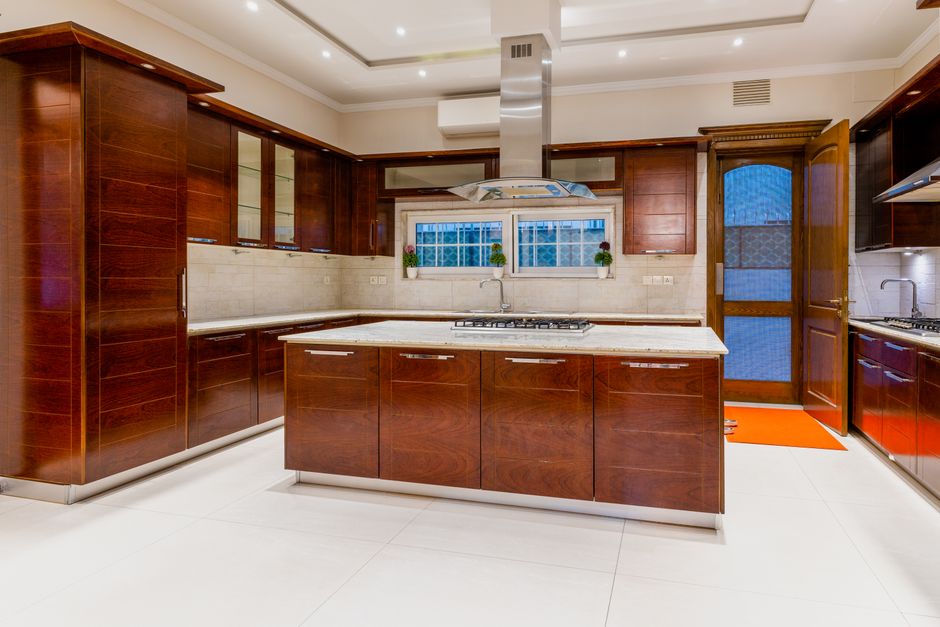 Sunlit dark cabinetry enhances kitchen ambience.