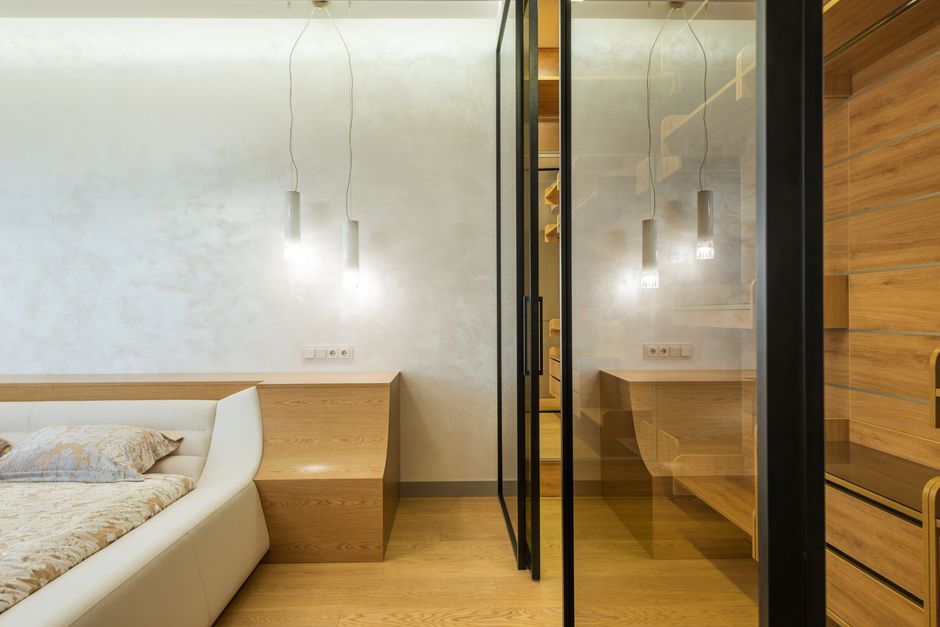 Modern interior features clear glass wall panels