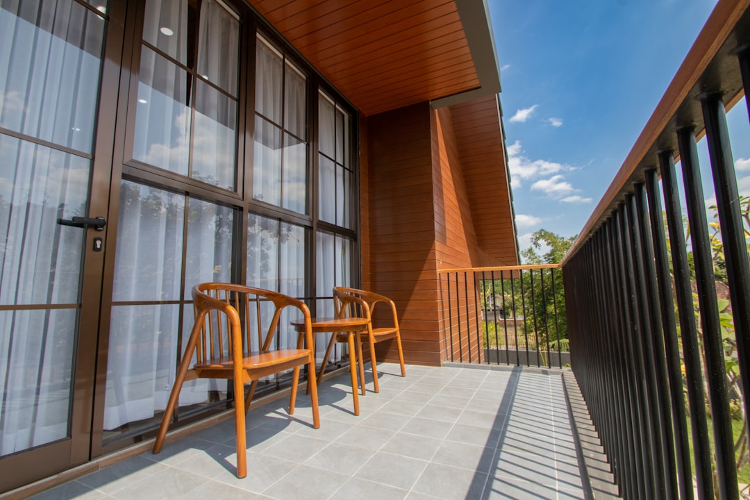 Small balcony with lush greenery and cushions. Small balcony with lush greenery and cushions.