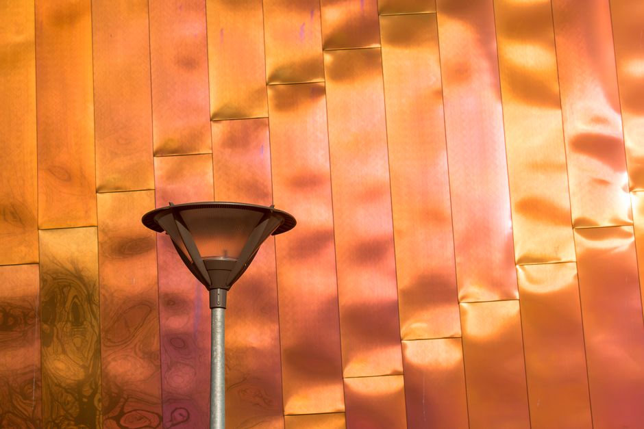 Elegant copper wall sconce in cozy lighting. Elegant copper wall sconce in cozy lighting.